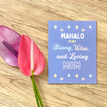 Load image into Gallery viewer, Mahalo card in cornflower blue wiht white, light blue and pink letters that says &quot;mahalo to my strong, wise and loving Mom.&quot;