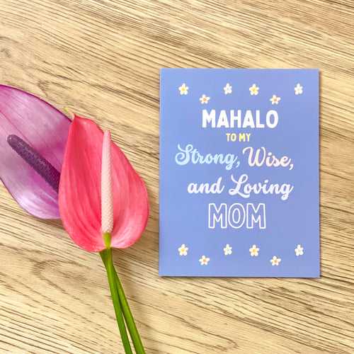 Mahalo card in cornflower blue wiht white, light blue and pink letters that says 